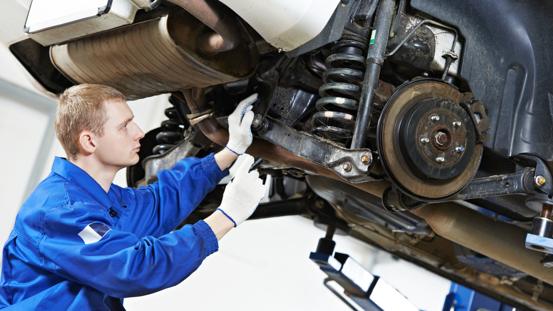 Mechanic conducting a suspension noise repair at Car Motive Auto in Houston